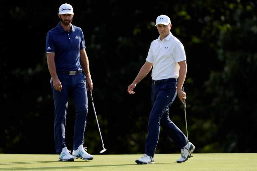 WESTBURY, NY - AUGUST 27:  Dustin Johnson and Jordan Spieth survey their putts on the 15th...