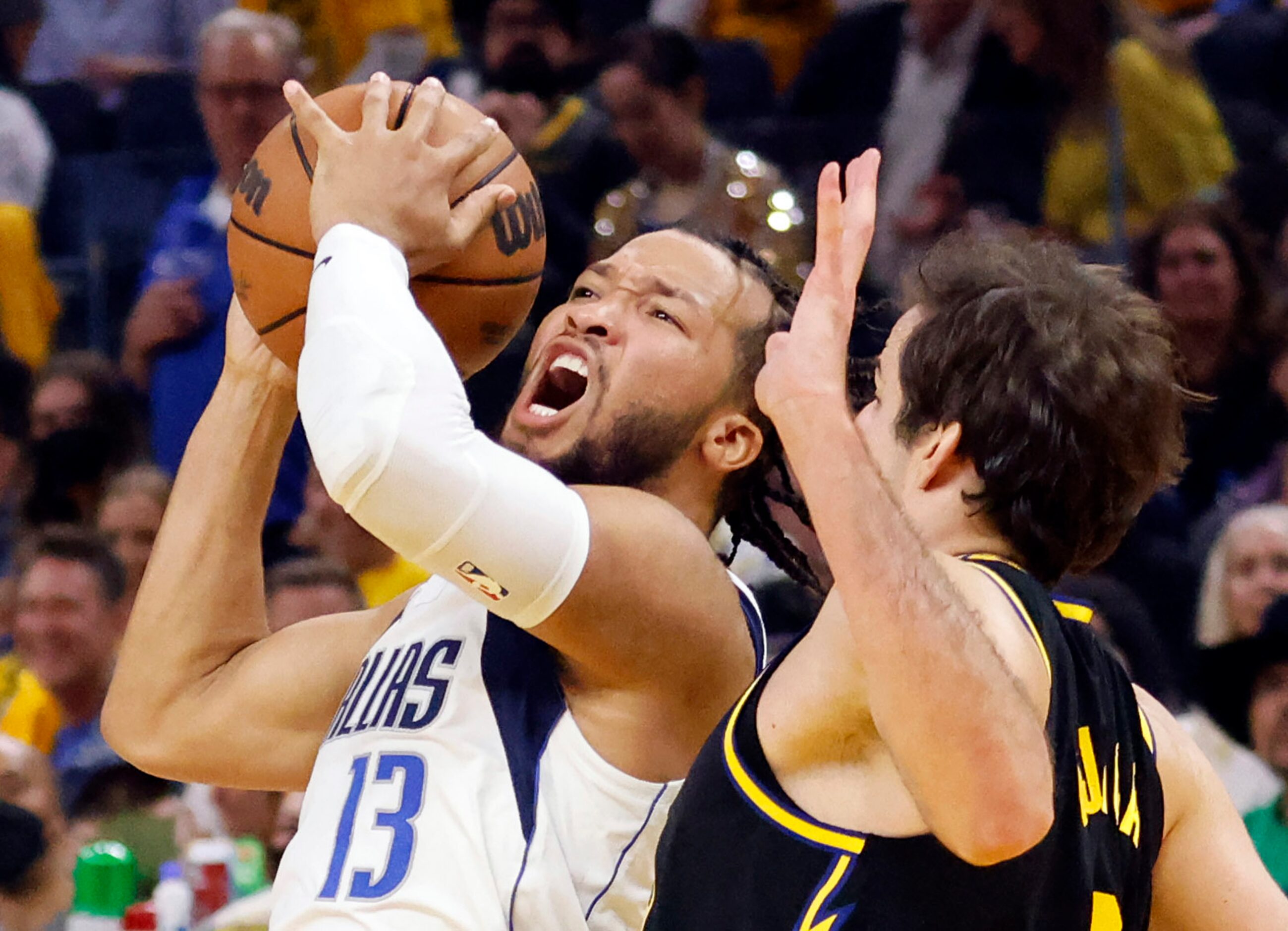 Dallas Mavericks guard Jalen Brunson (13) passes the ball as he’s bumped by Golden State...