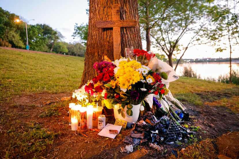 Flowers, candles and a cross make up a memorial for the 19-year-old who died after his...