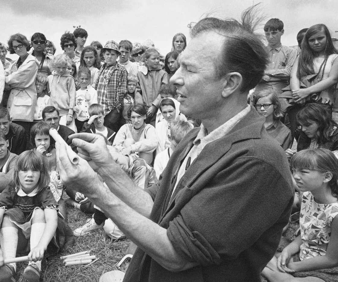 In 1966, Pete Seeger conducts an instrument-making session on Children's Day at the Newport...