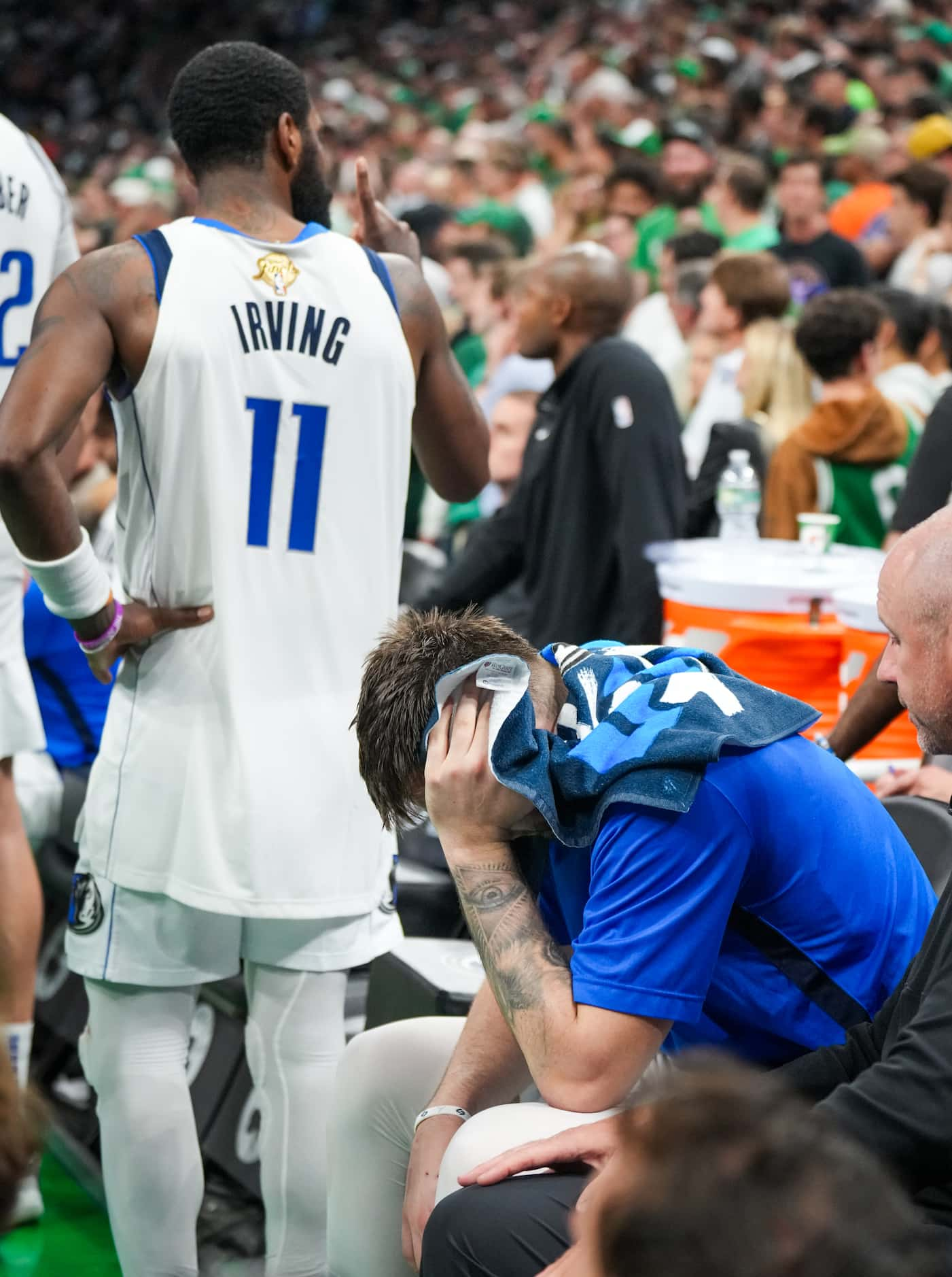 Dallas Mavericks guard Luka Doncic (bottom) and guard Kyrie Irving on the bench in the final...