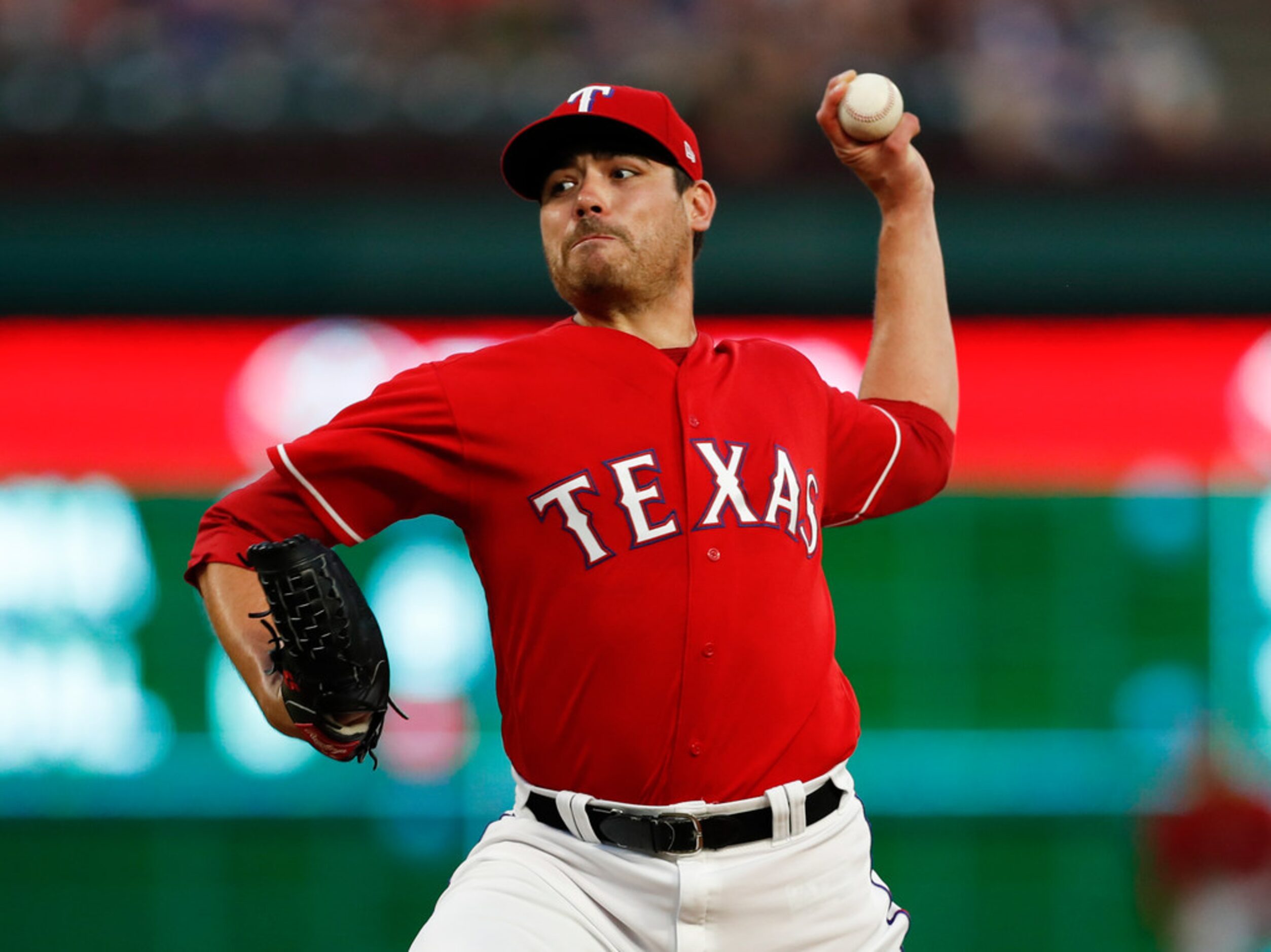 Texas Rangers starting pitcher Matt Moore delivers a pitch to a Colorado Rockies' batter...