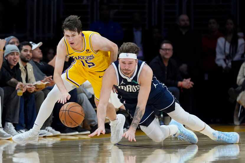 Los Angeles Lakers guard Austin Reaves (15) reaches for a loose ball next to Dallas...