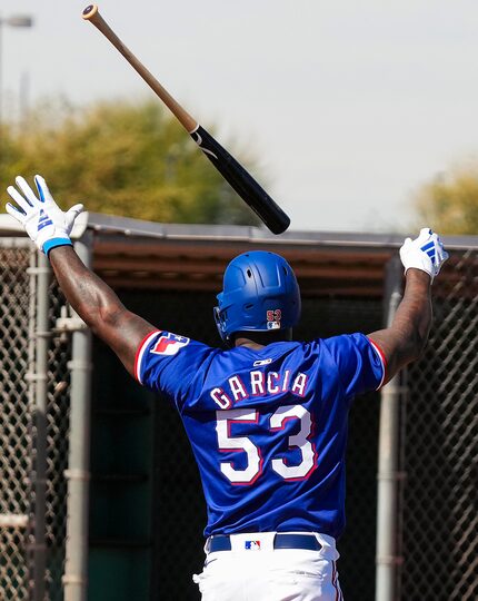 Texas Rangers outfielder Adolis García tosses his bat while facing pitcher José Leclerc in...