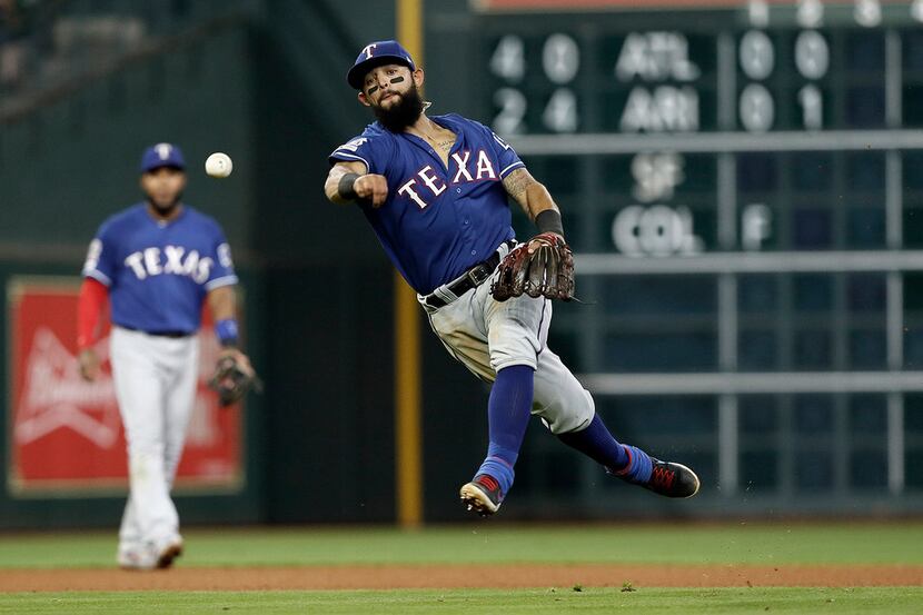 Second baseman Rougned Odor of the Texas Rangers throws out Jose Altuve of the Houston...