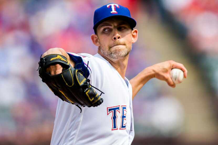 Texas Rangers starting pitcher Mike Minor (23) pitches during the first inning of an opening...