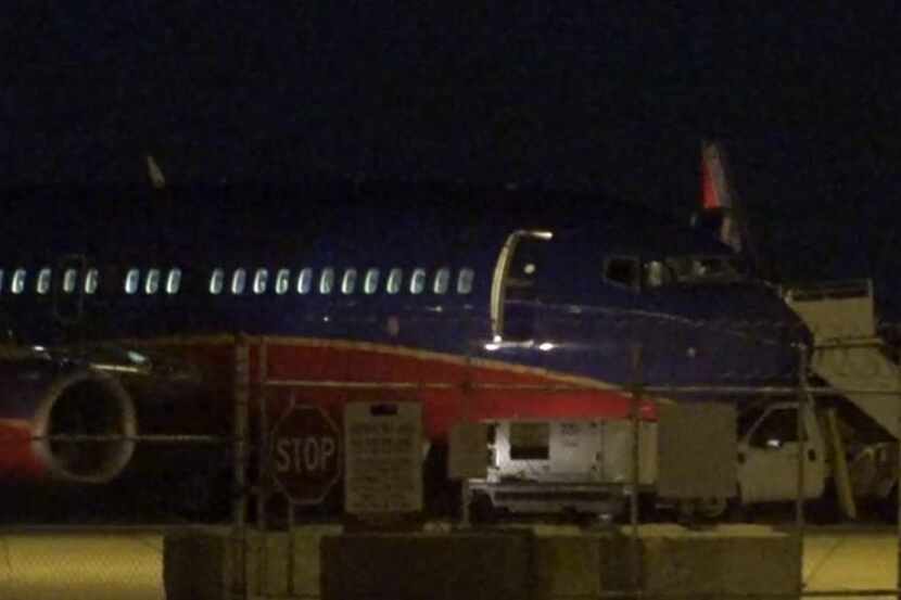 A Southwest Airlines plane sits on the runway at DFW Airport after it made an emergency...