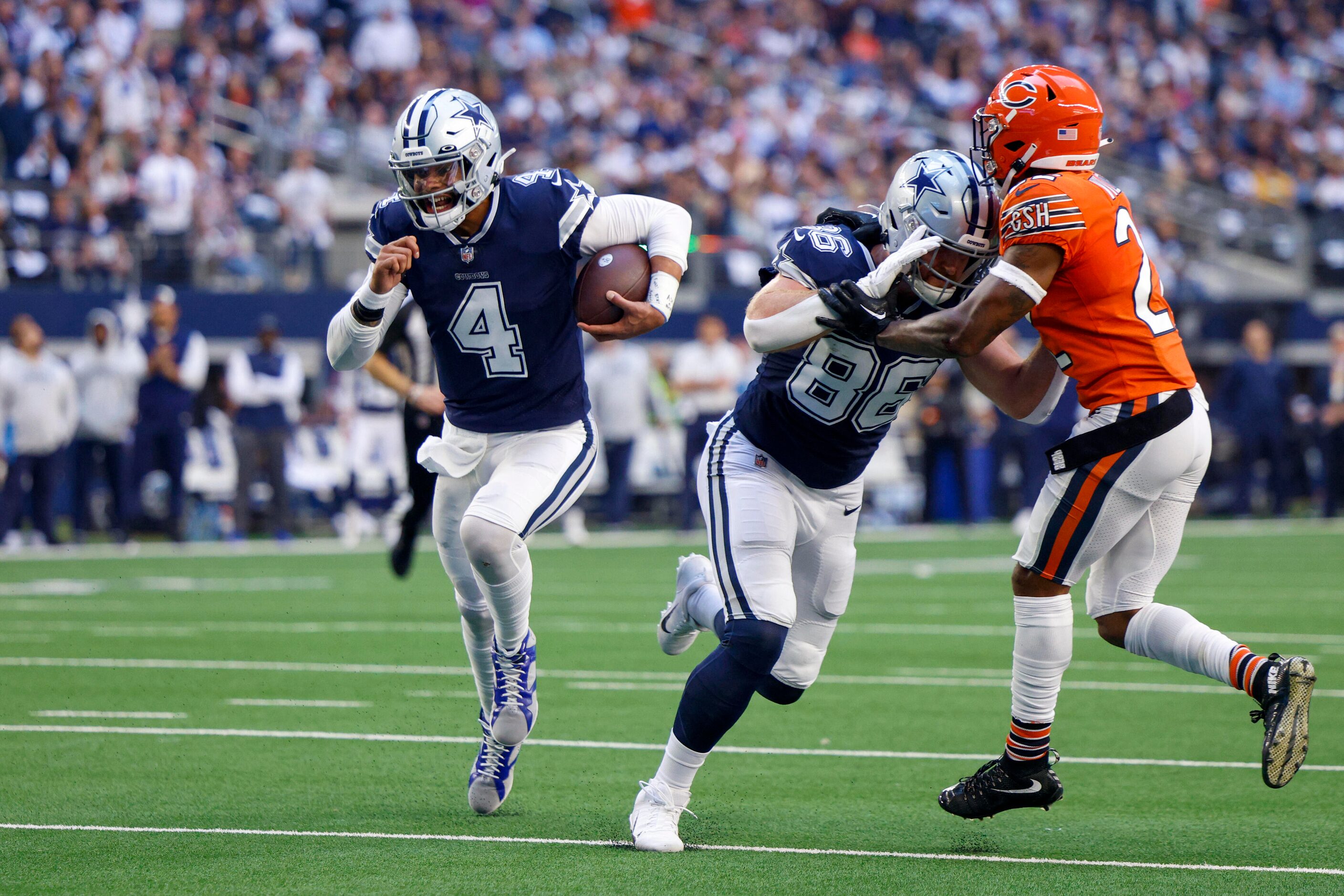 Dallas Cowboys quarterback Dak Prescott (4) runs for a touchdown as tight end Dalton Schultz...