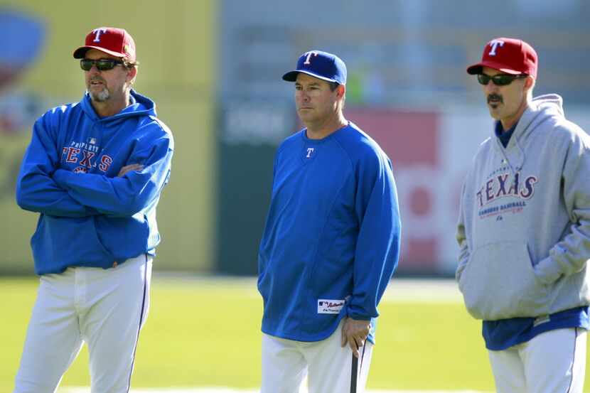 Texas Rangers bullpen coach Andy Hawkins, left, special assistant Greg Maddux and pitching...