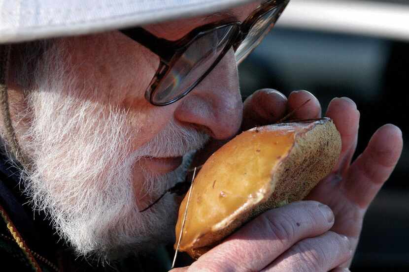 File: Bill Freedman smells a mushroom that he collected along the Mills Canyon Park Trail.