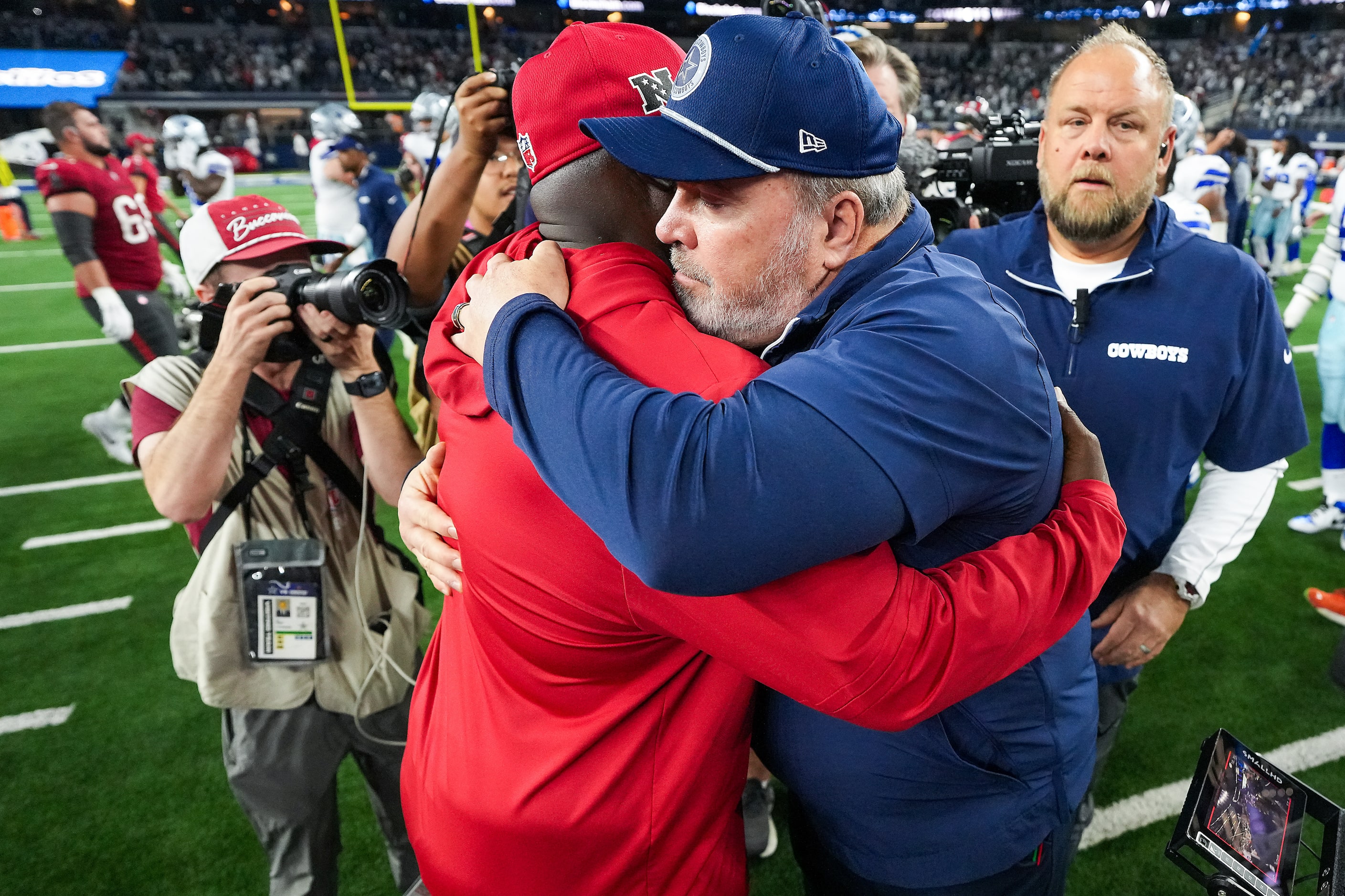 Dallas Cowboys head coach Mike McCarthy hugs Tampa Bay Buccaneers head coach Todd Bowles...