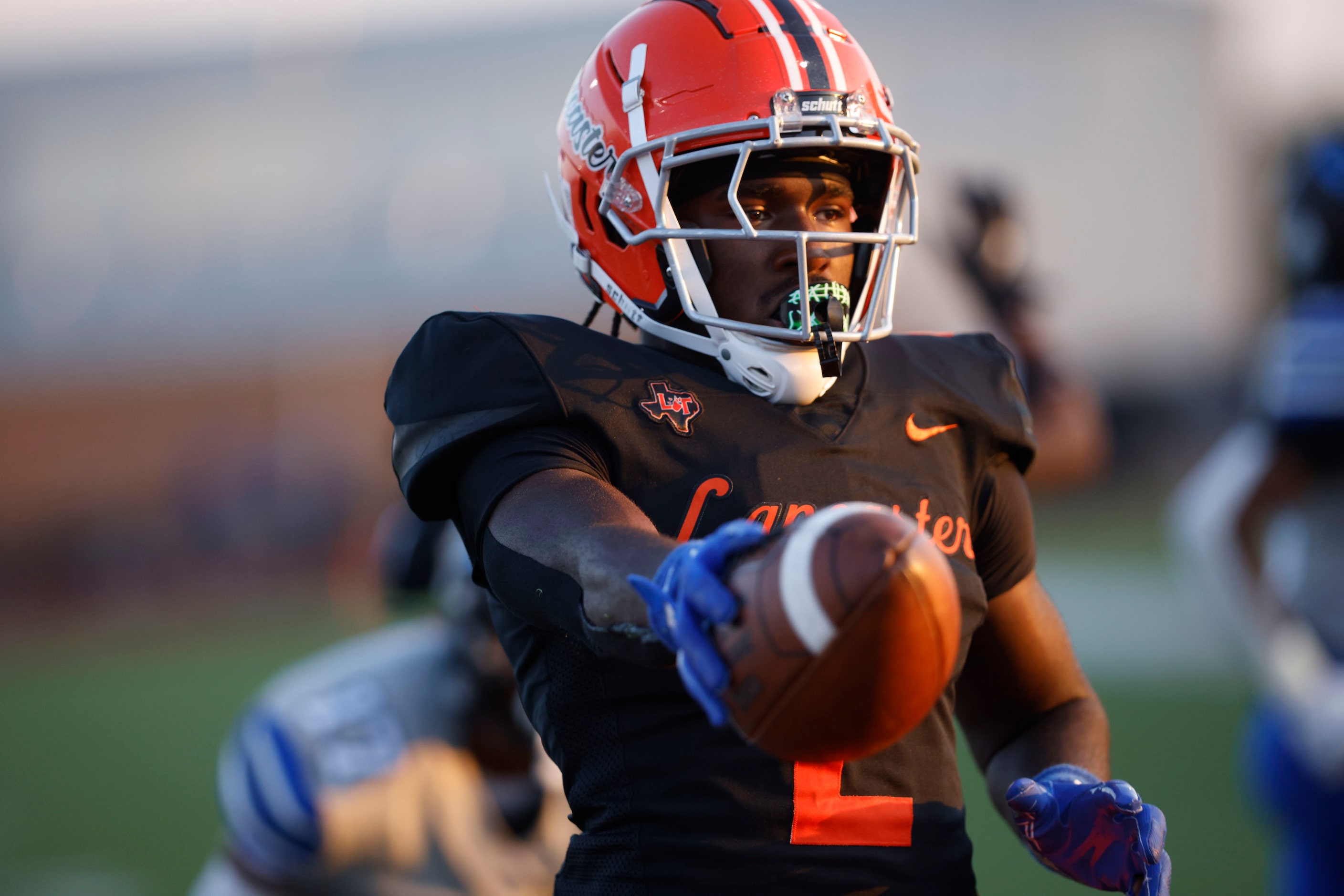 Lancaster’s Izayah Lee gestures after scoring a touchdown in the first half of a high school...