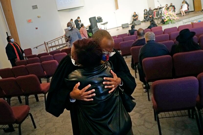 Pastor Bryant Phelps hugs Iva Culberson last Sunday before Church of the Disciple United...