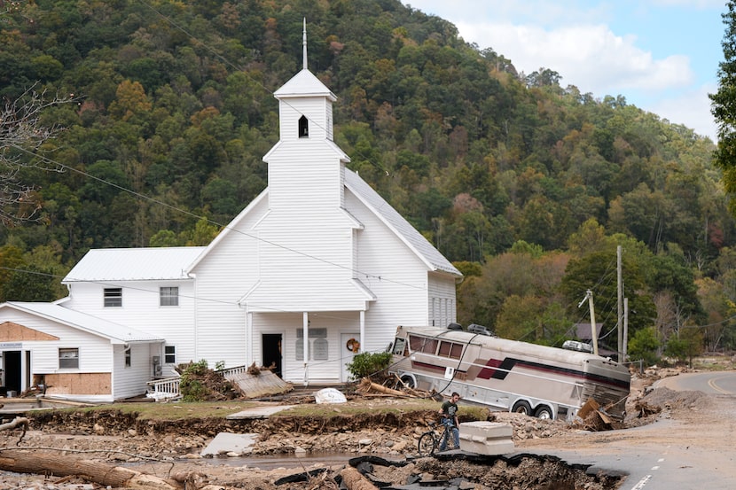 A bus sat stuck Thursday after being shoved against Laurel Branch Baptist Church in...