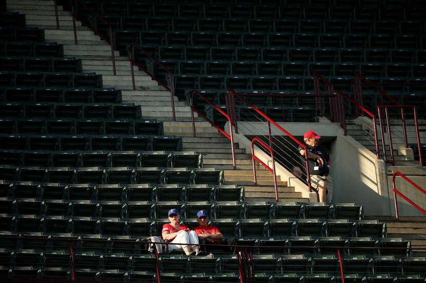 Fans and an usher in the upper deck near the beginning of a Major League Baseball game...