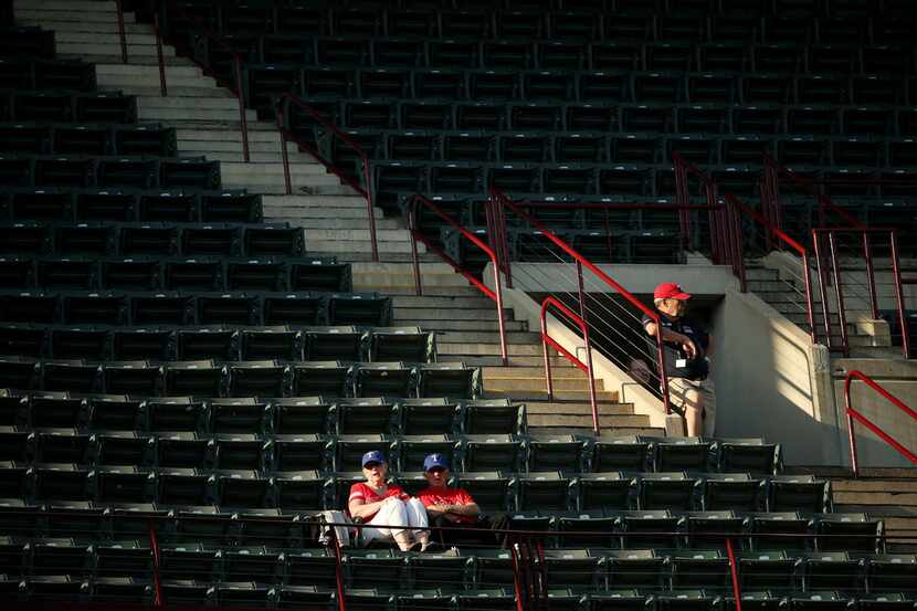 Fans and an usher in the upper deck near the beginning of a Major League Baseball game...