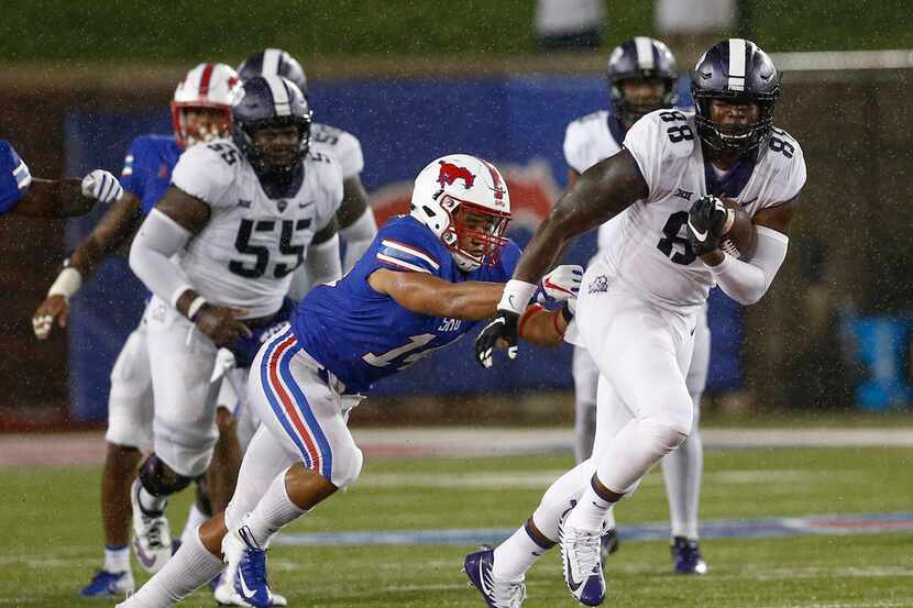 TCU tight end Artayvious Lynn (88) tries to get away form SMU linebacker Richard Moore (14)...