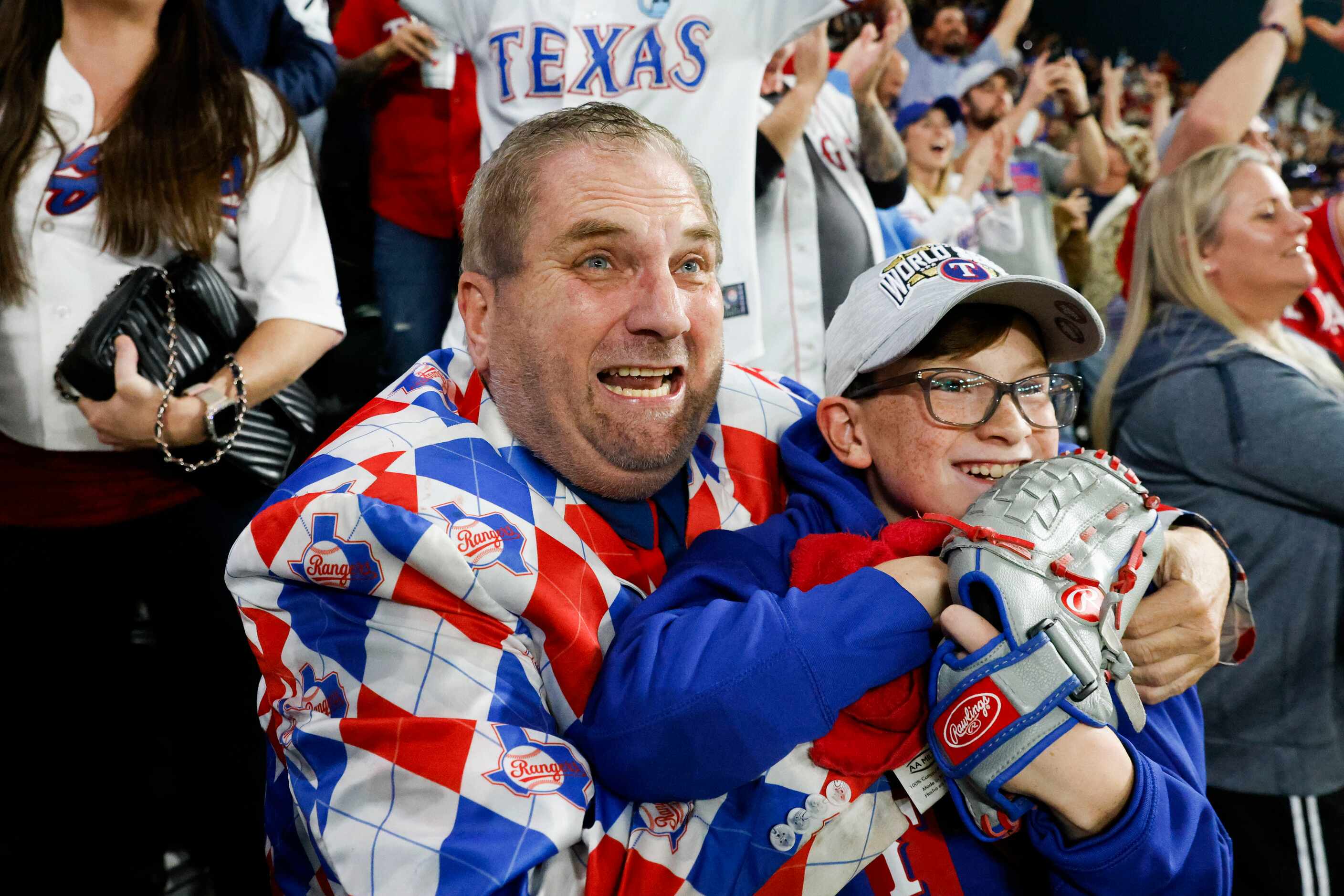Texas Rangers fan from 1972, Terry Cox, (left) from Tyler, TX, embracing his son Landry, 13,...