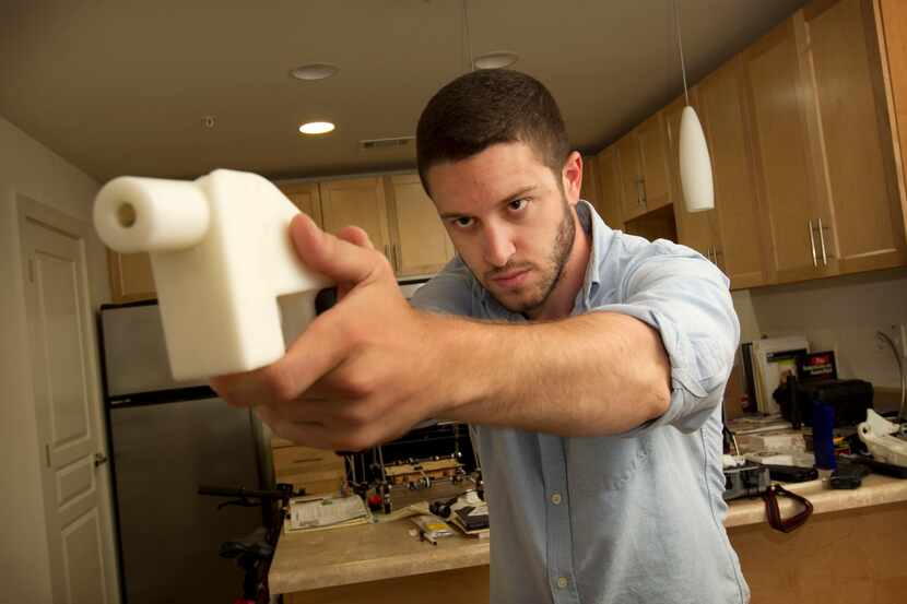 Cody Wilson shows the first completely 3-D-printed handgun, The Liberator, at his home in...