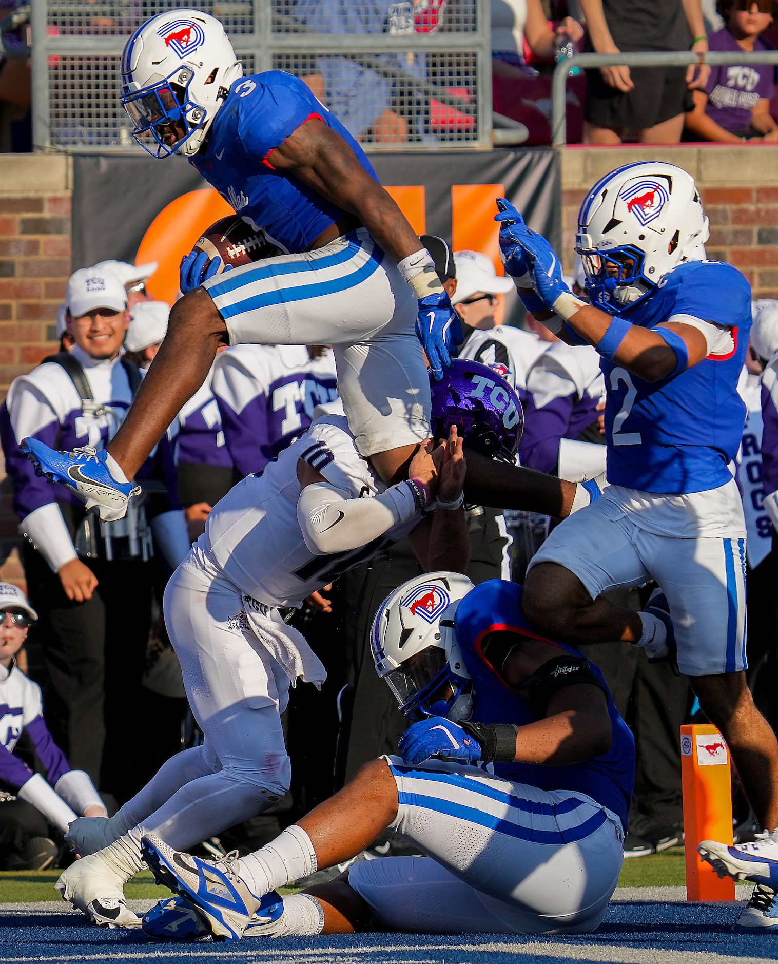 SMU safety Ahmaad Moses (3) leaps over TCU quarterback Josh Hoover (10) as he returns an...