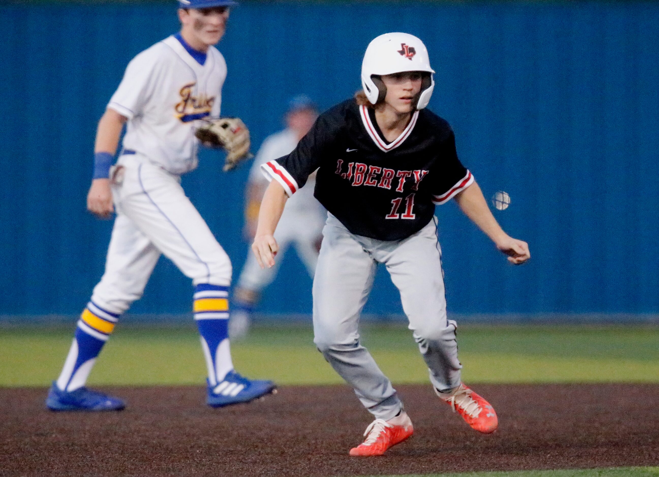 Liberty pinch runner Caden Wartluft (11) runs the base path on his way to third base in the...