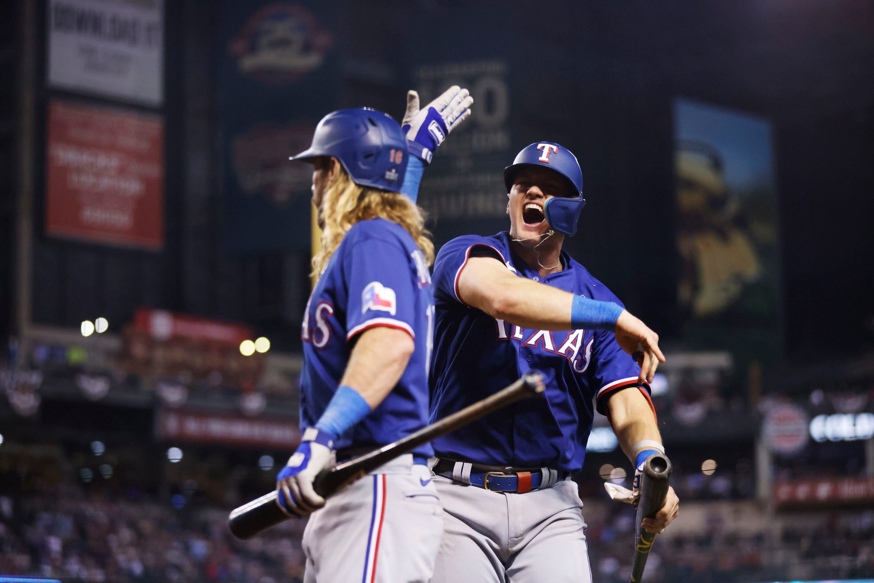 Texas Rangers’ Josh Jung, right, celebrates with Travis Jankowski after scoring on a single...