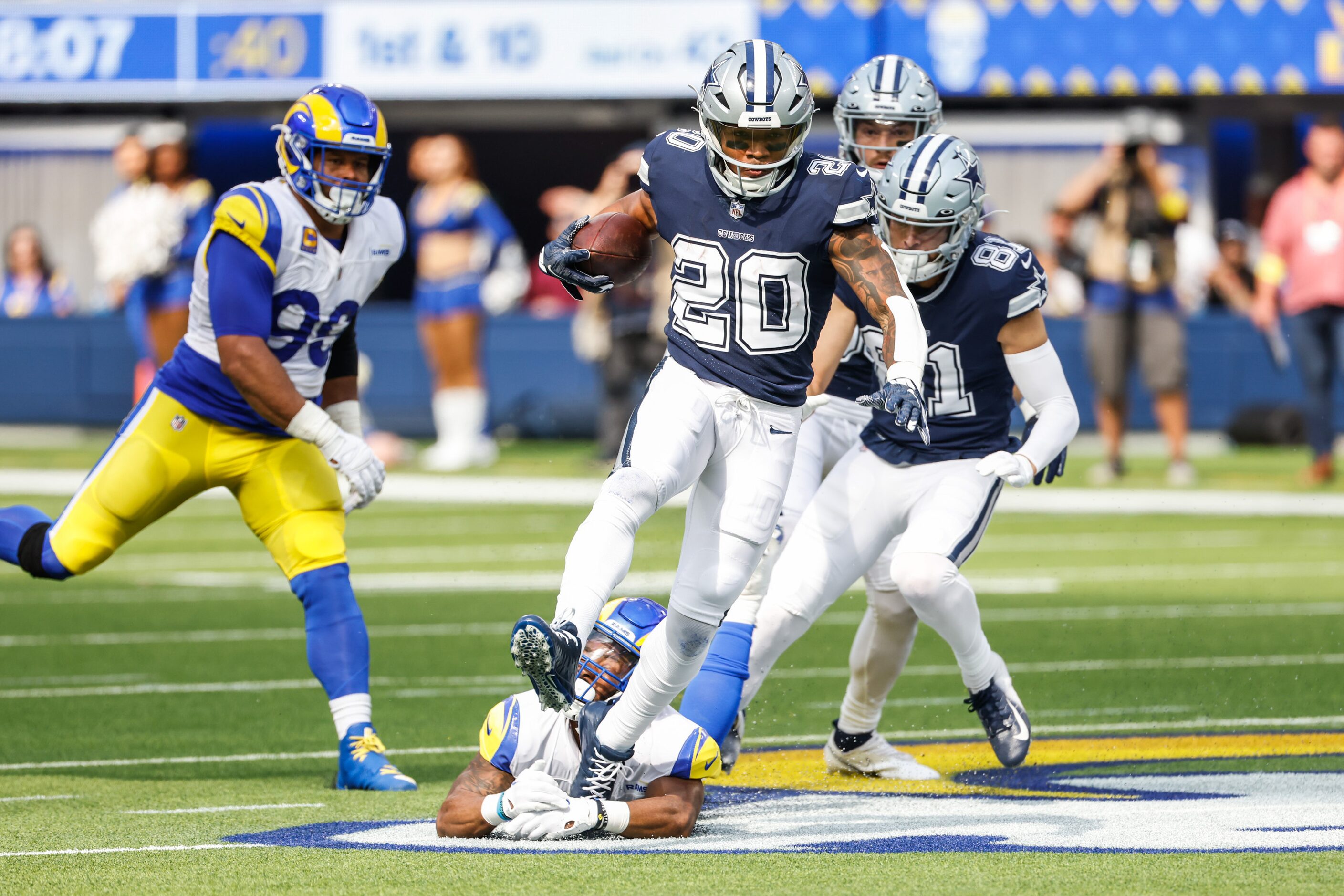 Dallas Cowboys running back Tony Pollard (20) gets past Los Angeles Rams safety Nick Scott...