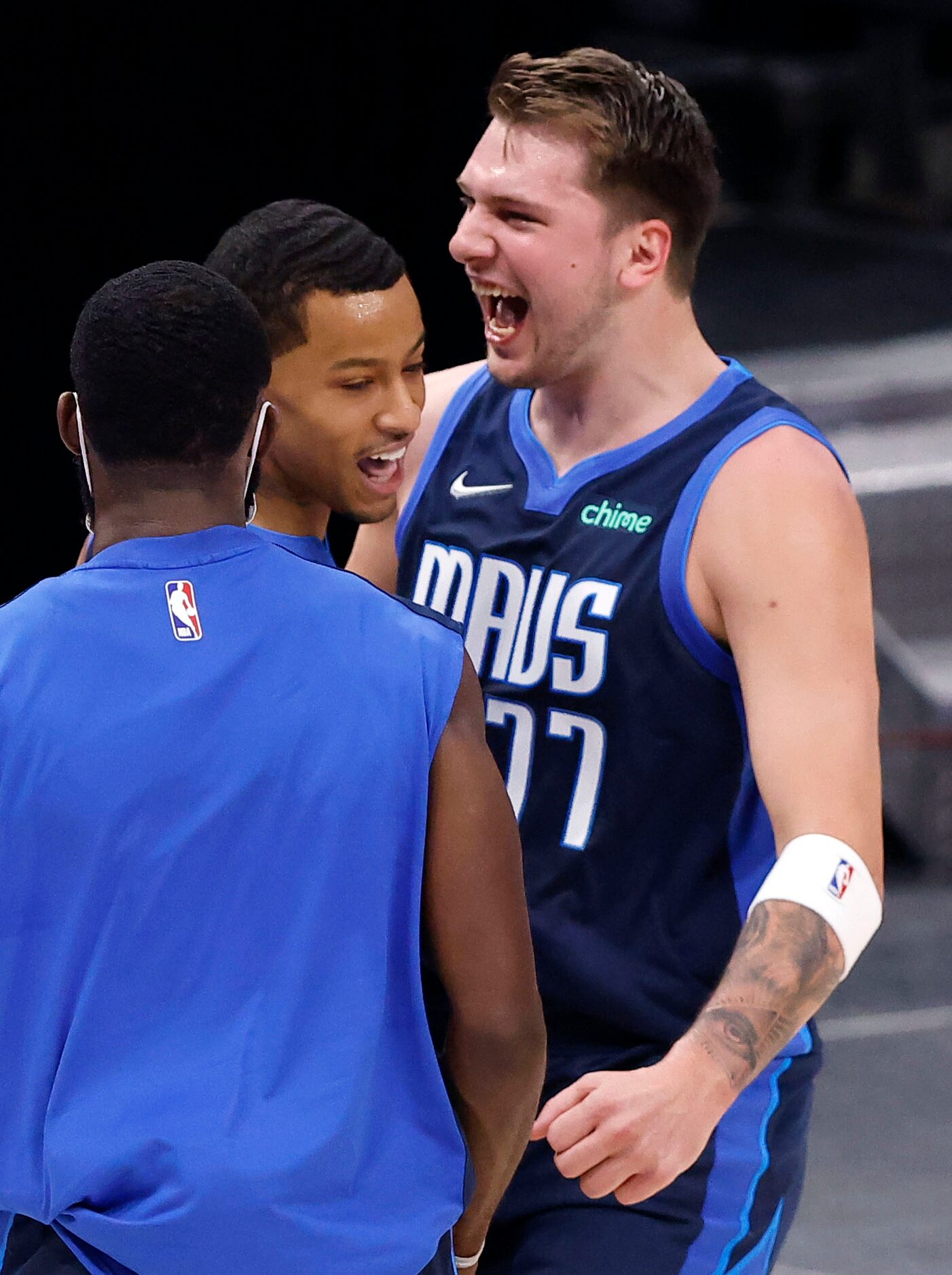 Dallas Mavericks guard Trey Burke (3) is congratulated by Luka Doncic (77) after hitting a...