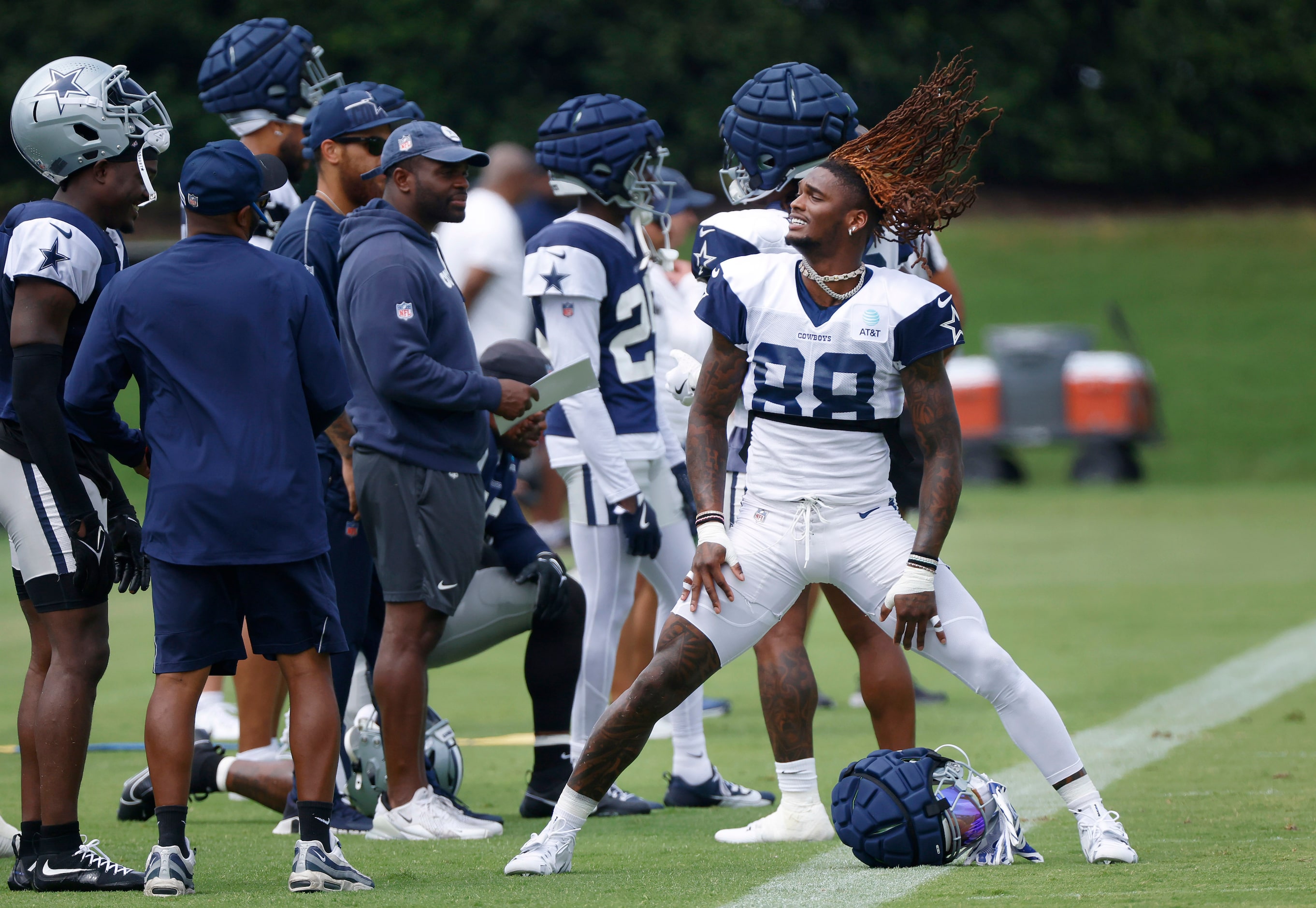 Dallas Cowboys wide receiver CeeDee Lamb (88) flips his hair back after stretching out...