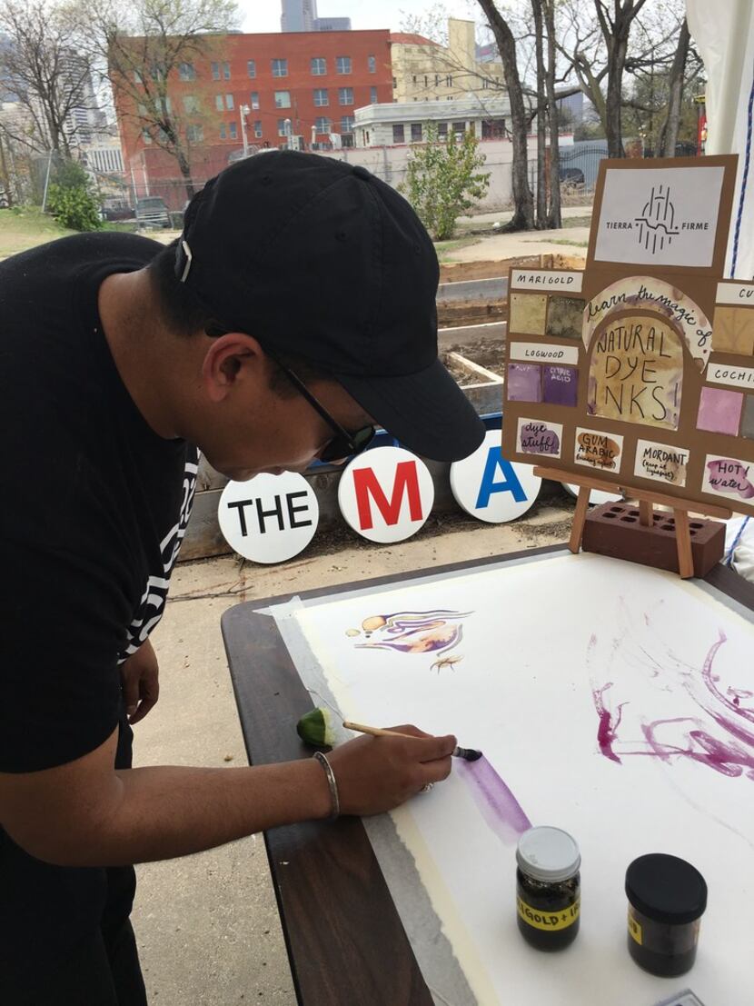 Lucas Martell, an artist, demonstrates how to paint with natural dyes at The MAC POP Garden...