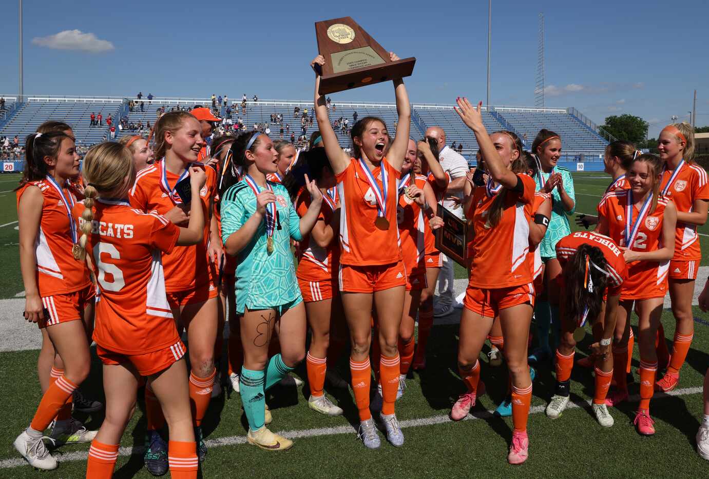 Celina's Makenna Brantley (4) hoists the state championship trophy as the team finished...