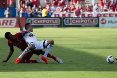 FC Dallas forward Atiba Harris (14) and Vancouver Whitecaps forward Blas Perez (27) gets...