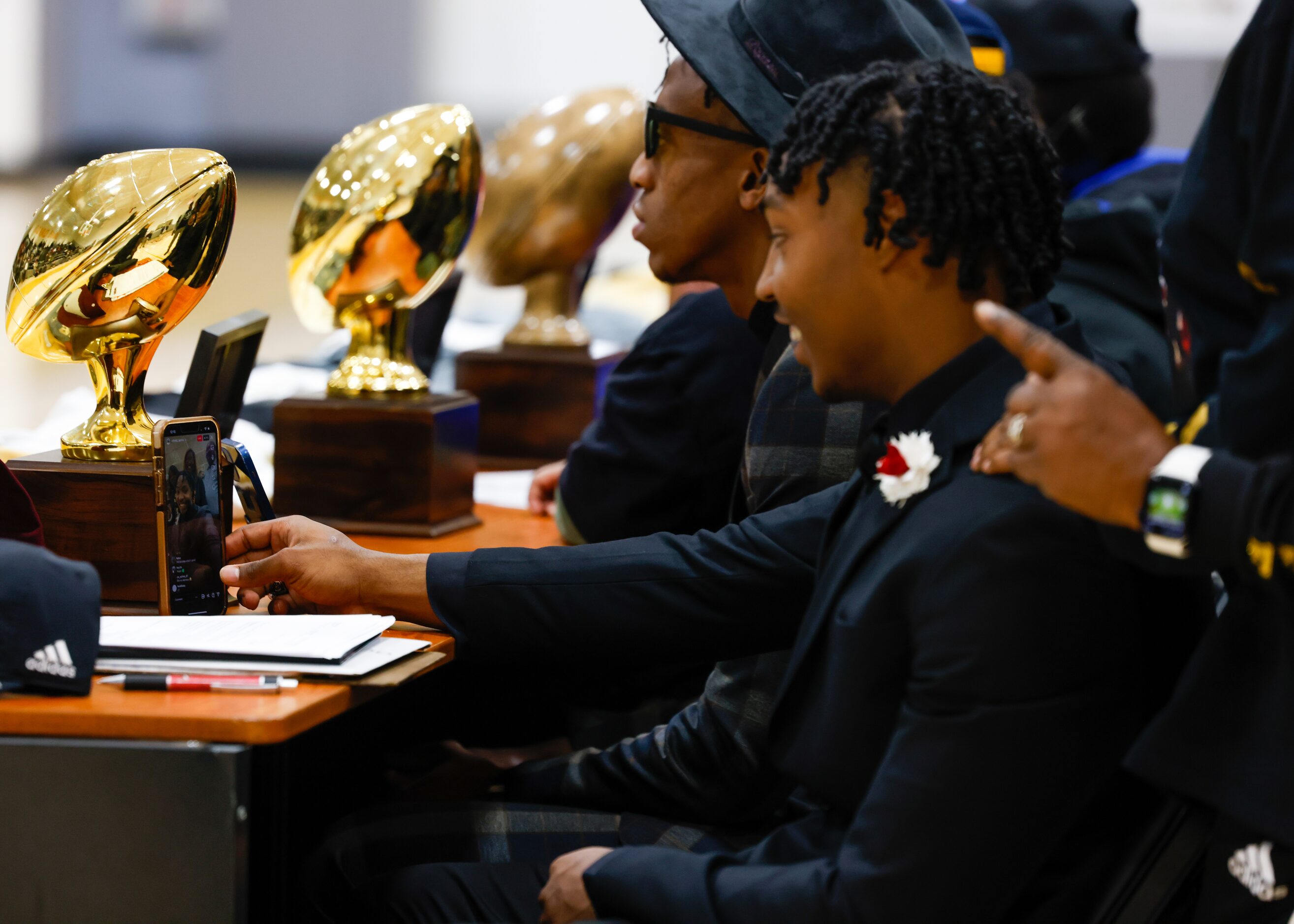 South Oak Cliff football player Jayvon Thomas (right) looks at the live stream running on...