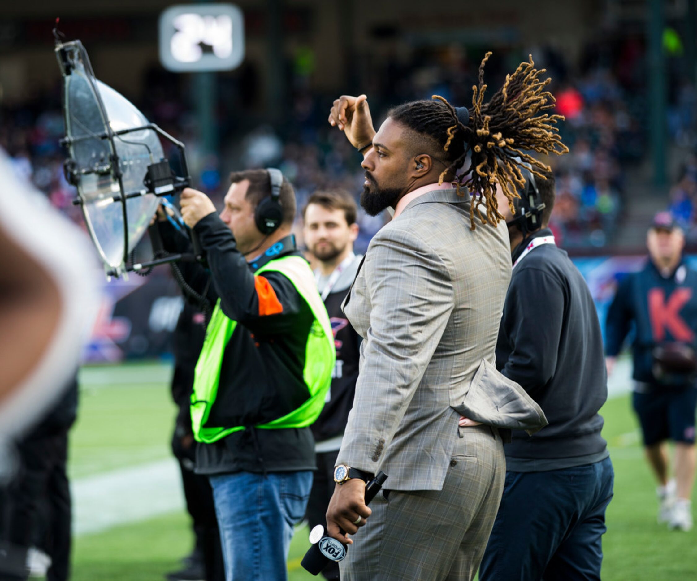 FOX Sports sideline reporter and New Orleans Saints defensive end Cam Jordan dances on the...