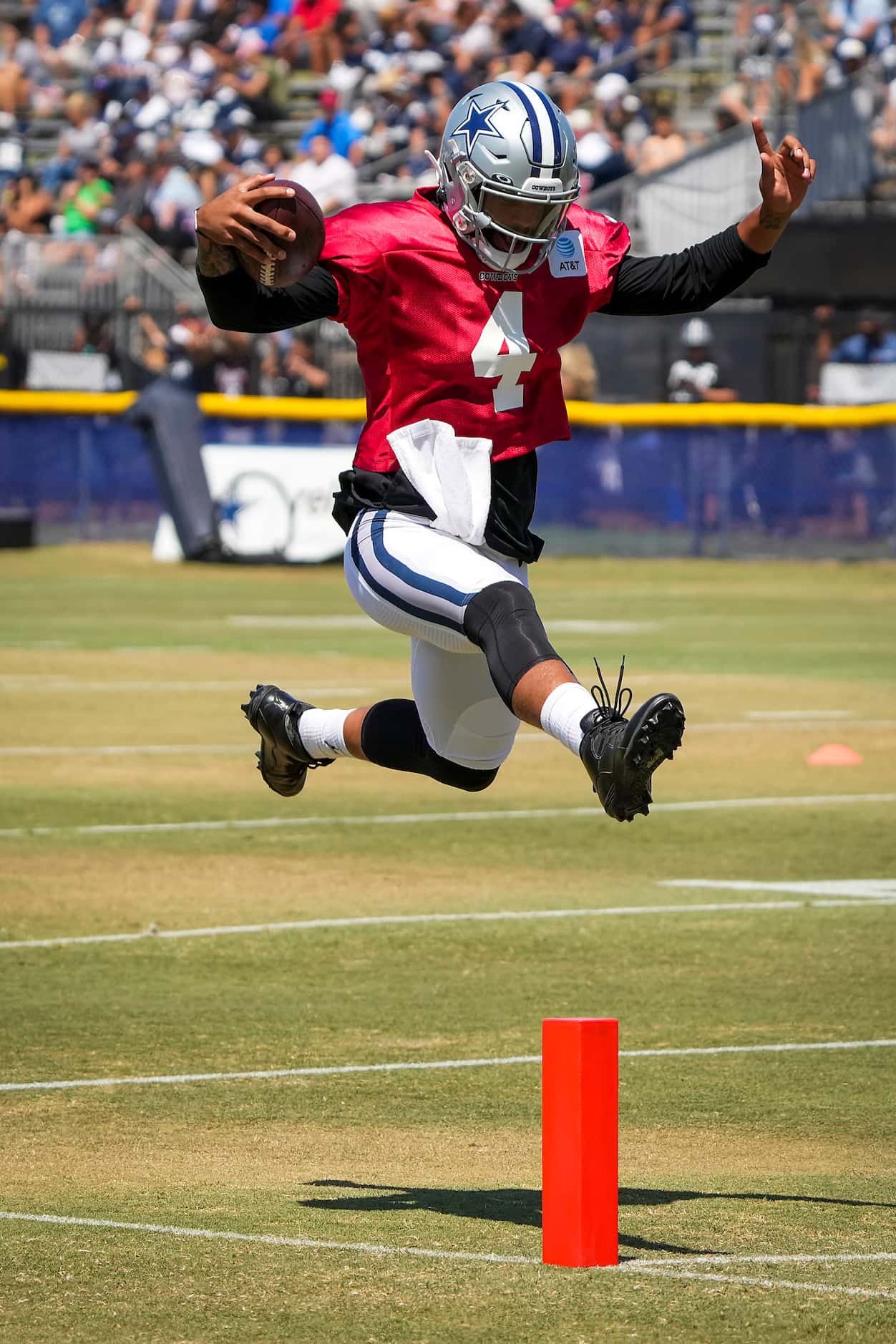 Dallas Cowboys quarterback Dak Prescott leaps into the end zone while running a drill during...