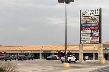 The parking lot of Pepper Square, an aging retail complex in Far North Dallas.