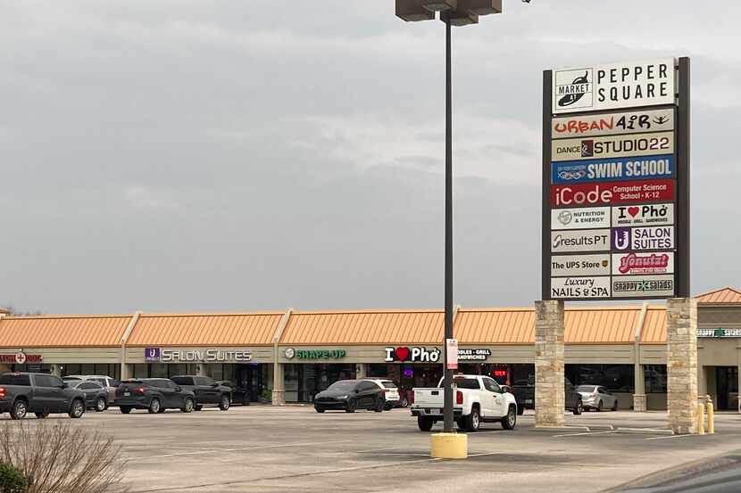 The parking lot of Pepper Square, an aging retail complex in Far North Dallas.
