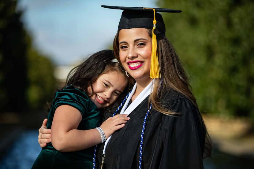 Itzel Ramirez Tapia poses with her cap and gown with her daughter Samantha Tapia, 5, at UTD....
