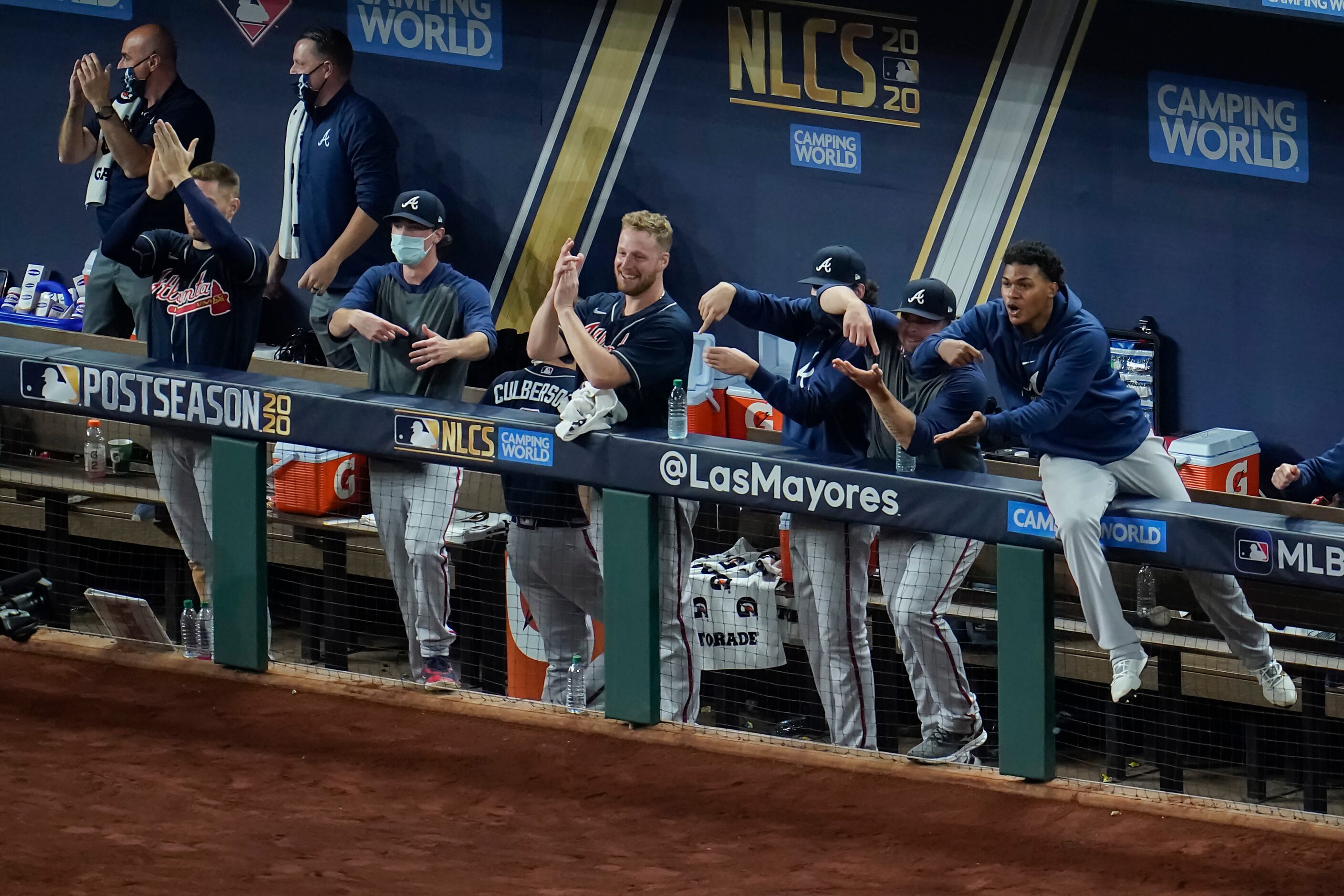 Atlanta Braves players celebrate in the dugout after a home run by second baseman Ozzie...