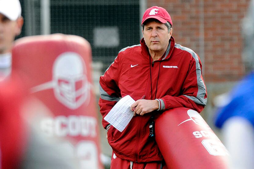 FILE - In this March 22, 2012, file photo, Washington State head coach Mike Leach watches...