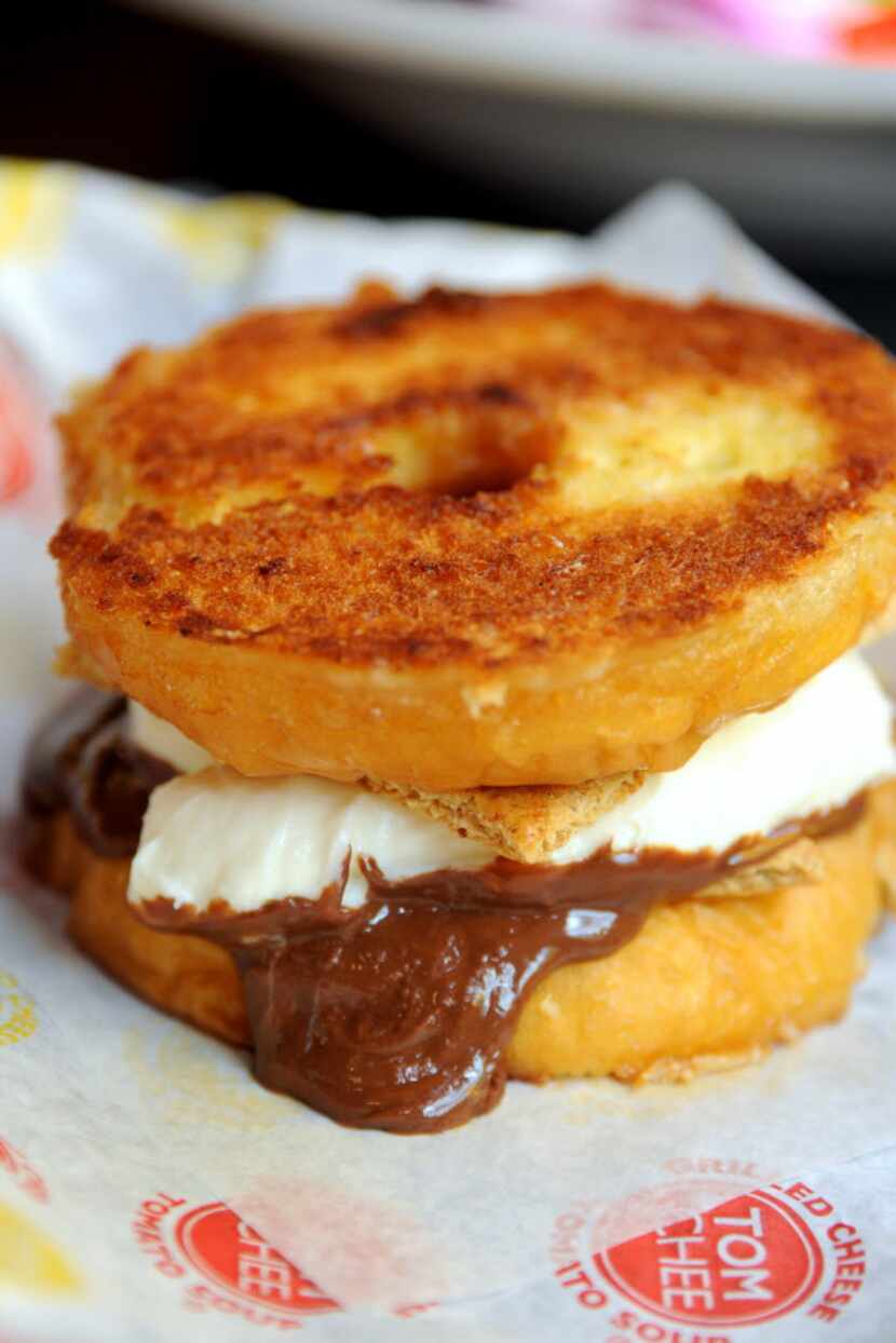 The s'mores grilled cheese donut has chocolate pieces, graham cracker and marshmallow...