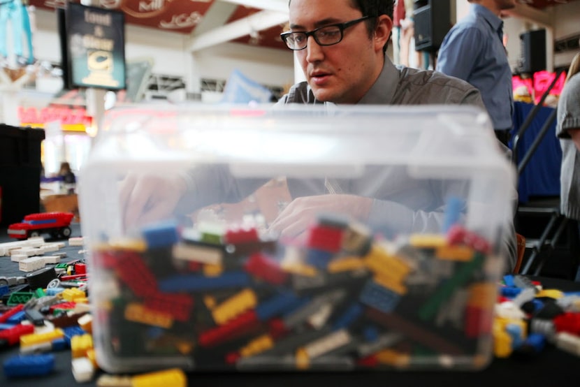 Lego builder Brandon Wike, 29, of Plano, works on his Lego creation during the "Brick...