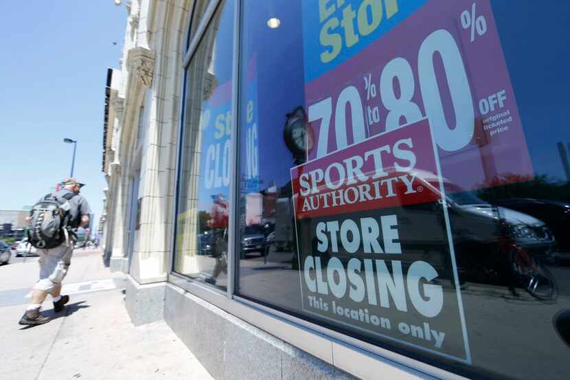 A shopper heads into the flagship location of retailer Sports Authority south of downtown...