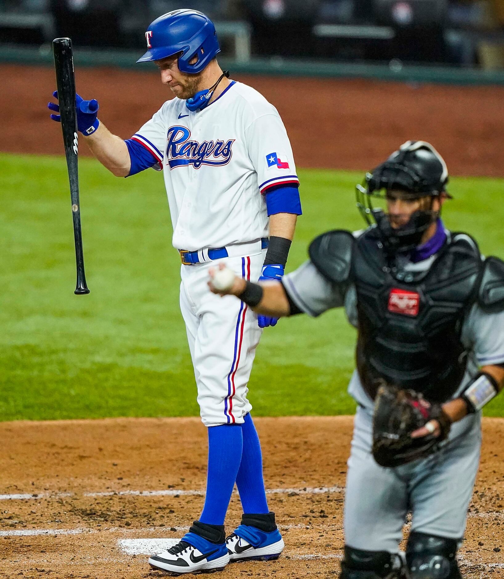 Texas Rangers third baseman Todd Frazier reacts after striking out against Colorado Rockies...