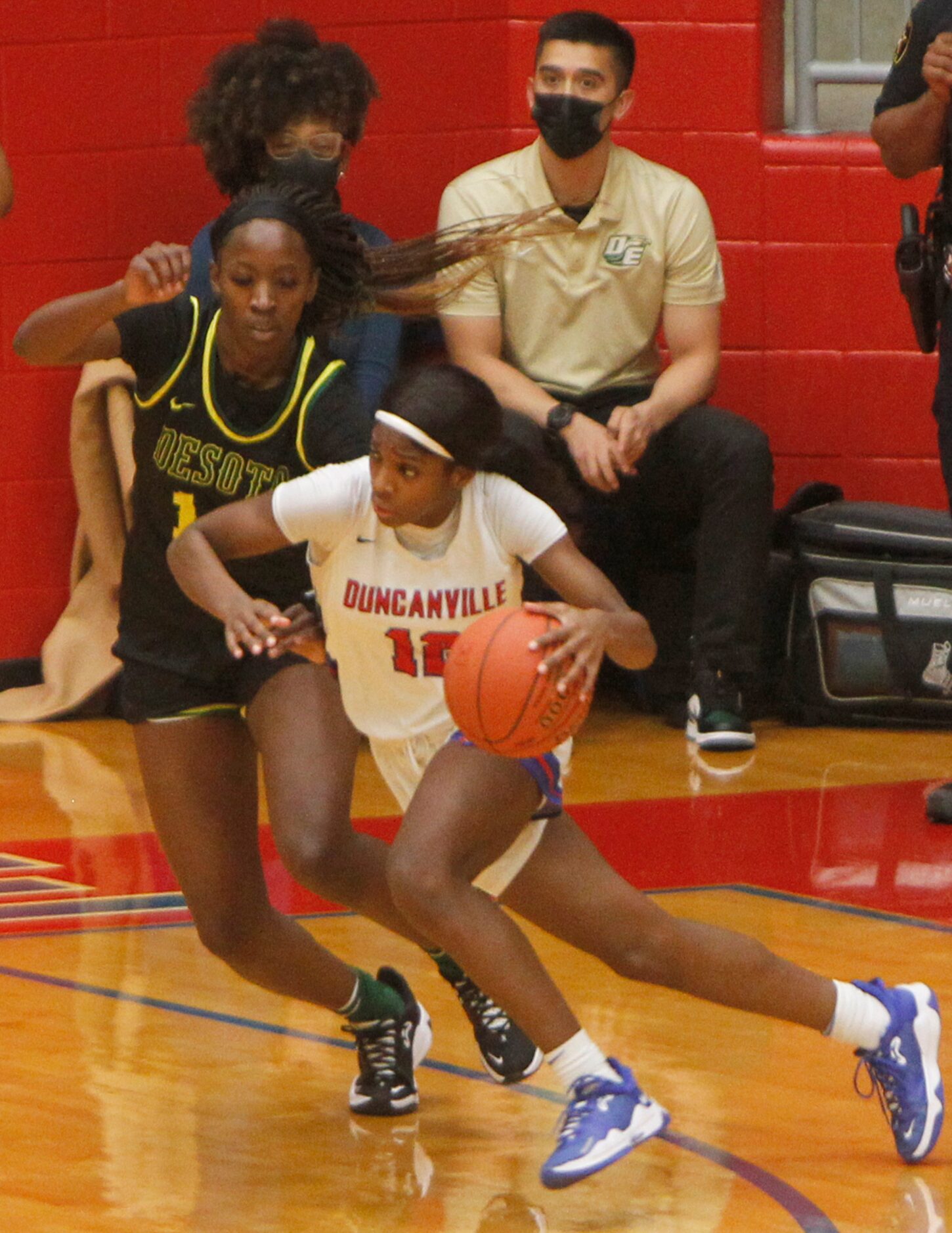 Duncanville Kaolin Kemp (12) drives against the defense of DeSoto's Amina Muhammad (14)...