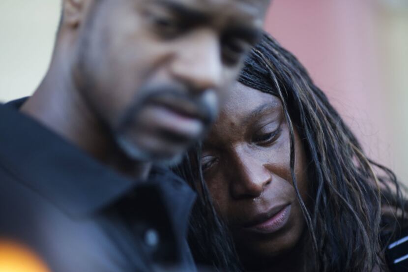 Sherry James, mother of 16-year-old Shania Gray,  is comforted at a candlelight vigil.