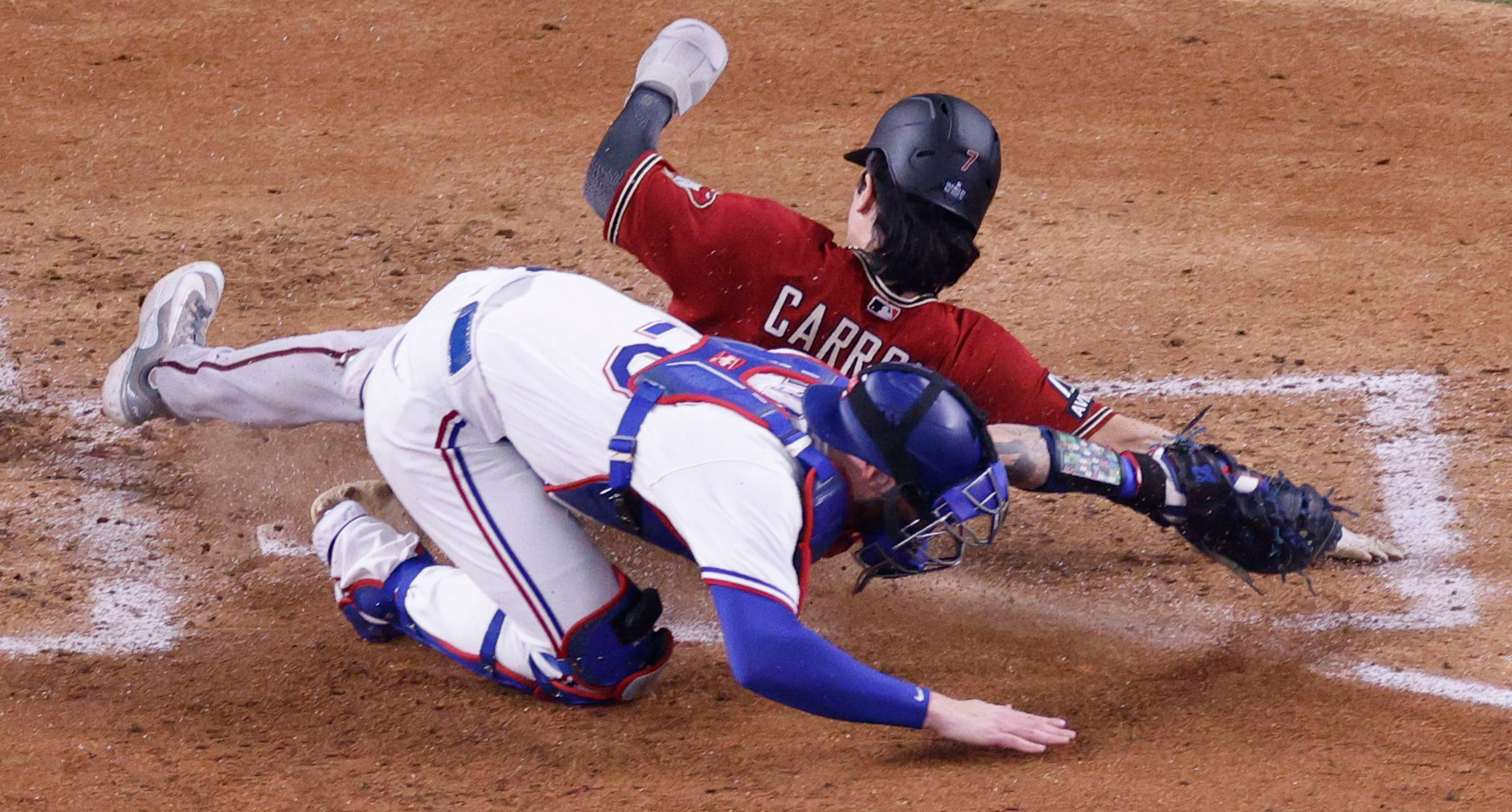 Arizona Diamondbacks left fielder Corbin Carroll (7) slides safely into home plate before a...