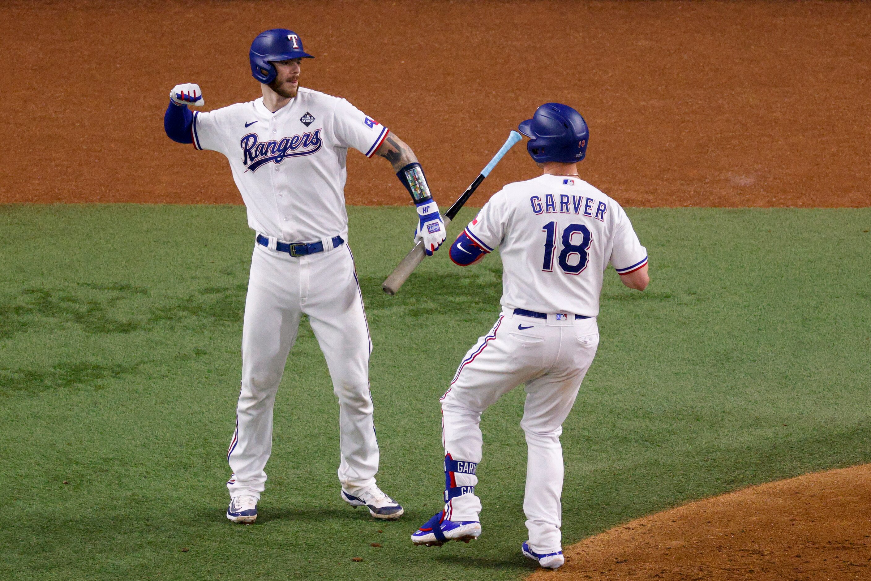 Texas Rangers catcher Mitch Garver (18) celebrates his home run with catcher Jonah Heim (28)...