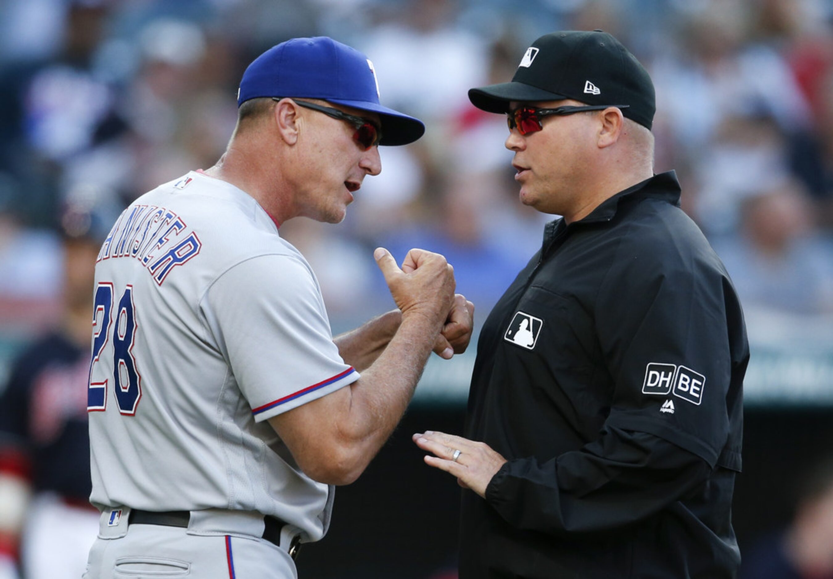 CLEVELAND, OH - MAY 01: Manager Jeff Banister #28 of the Texas Rangers discusses a call with...