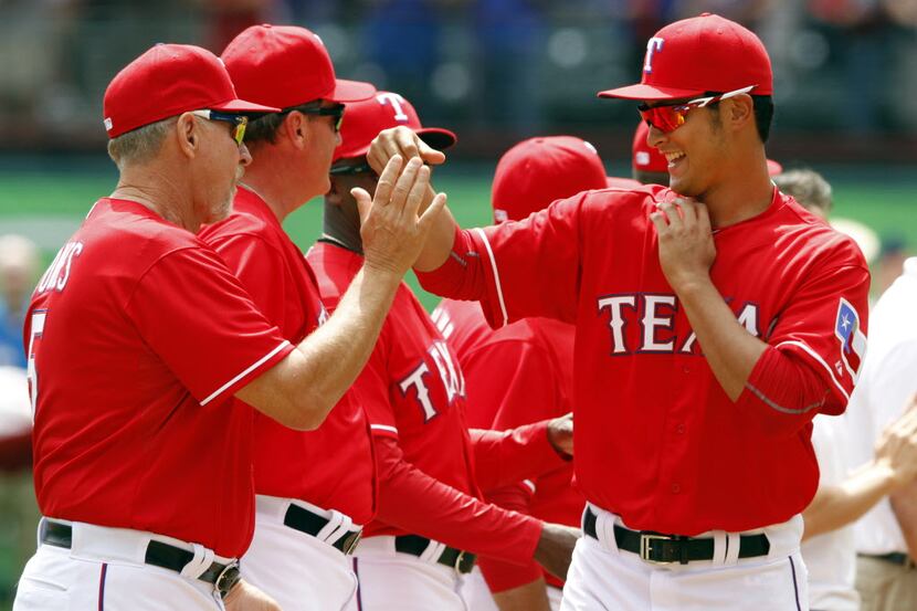 Texas Rangers starting pitcher Yu Darvish (11) and Texas Rangers Bobby Jones (5) share a...